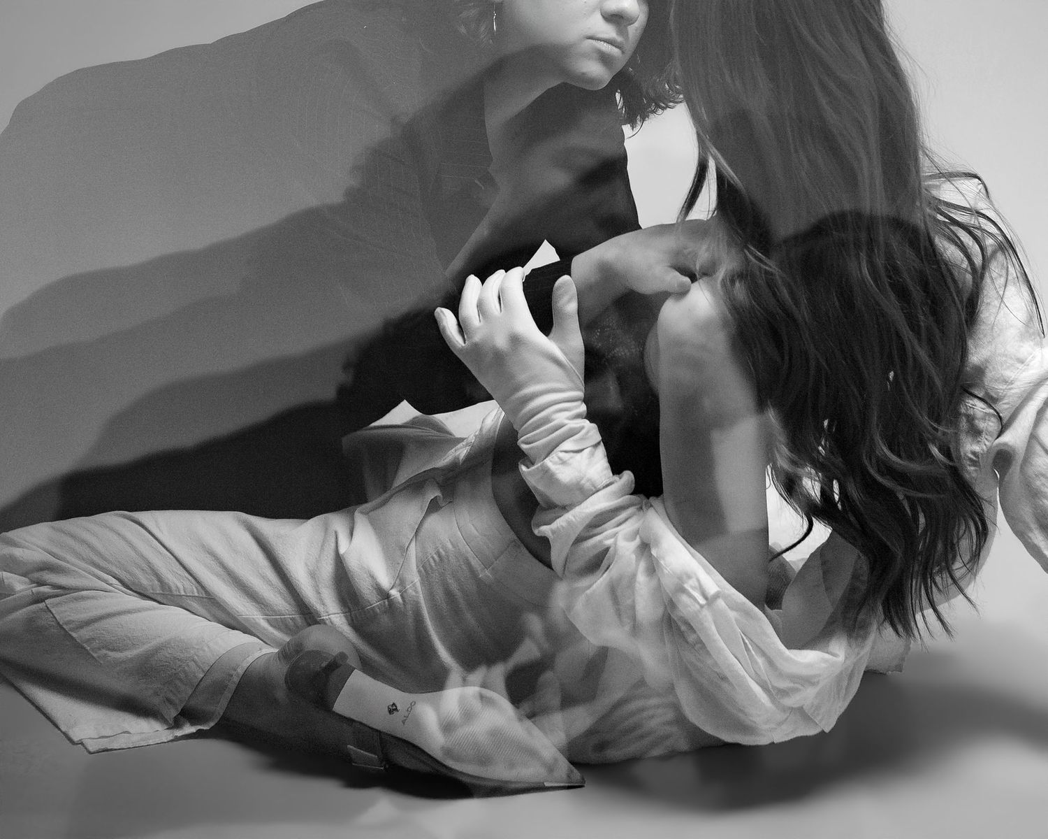 Black and white artistic photo series showing graceful dance-like movements and poses in flowing fabric against white backdrop.