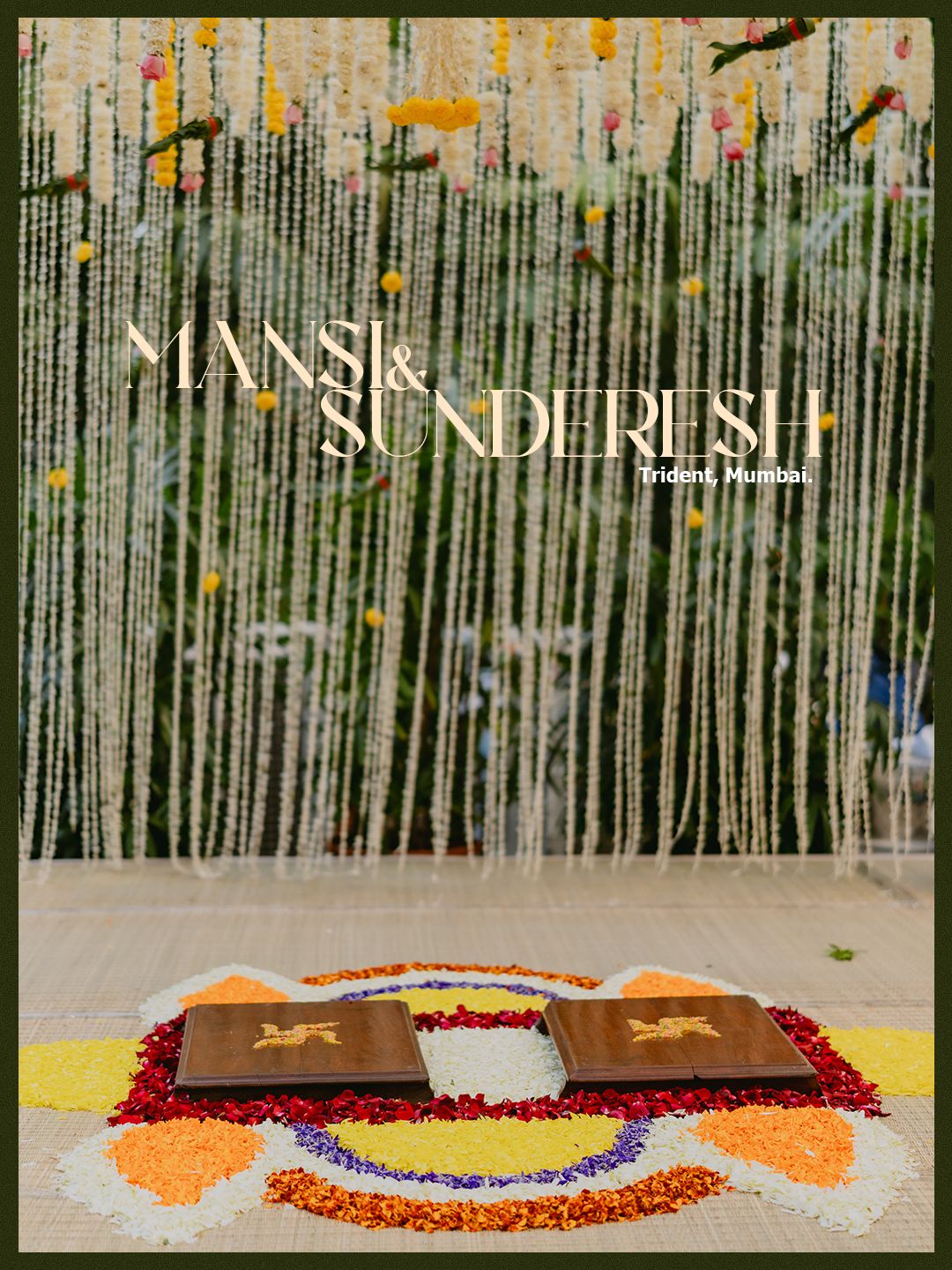 Elegant wedding backdrop for Mansi and Sunderesh at Trident Mumbai with floral curtains and colorful rangoli design.