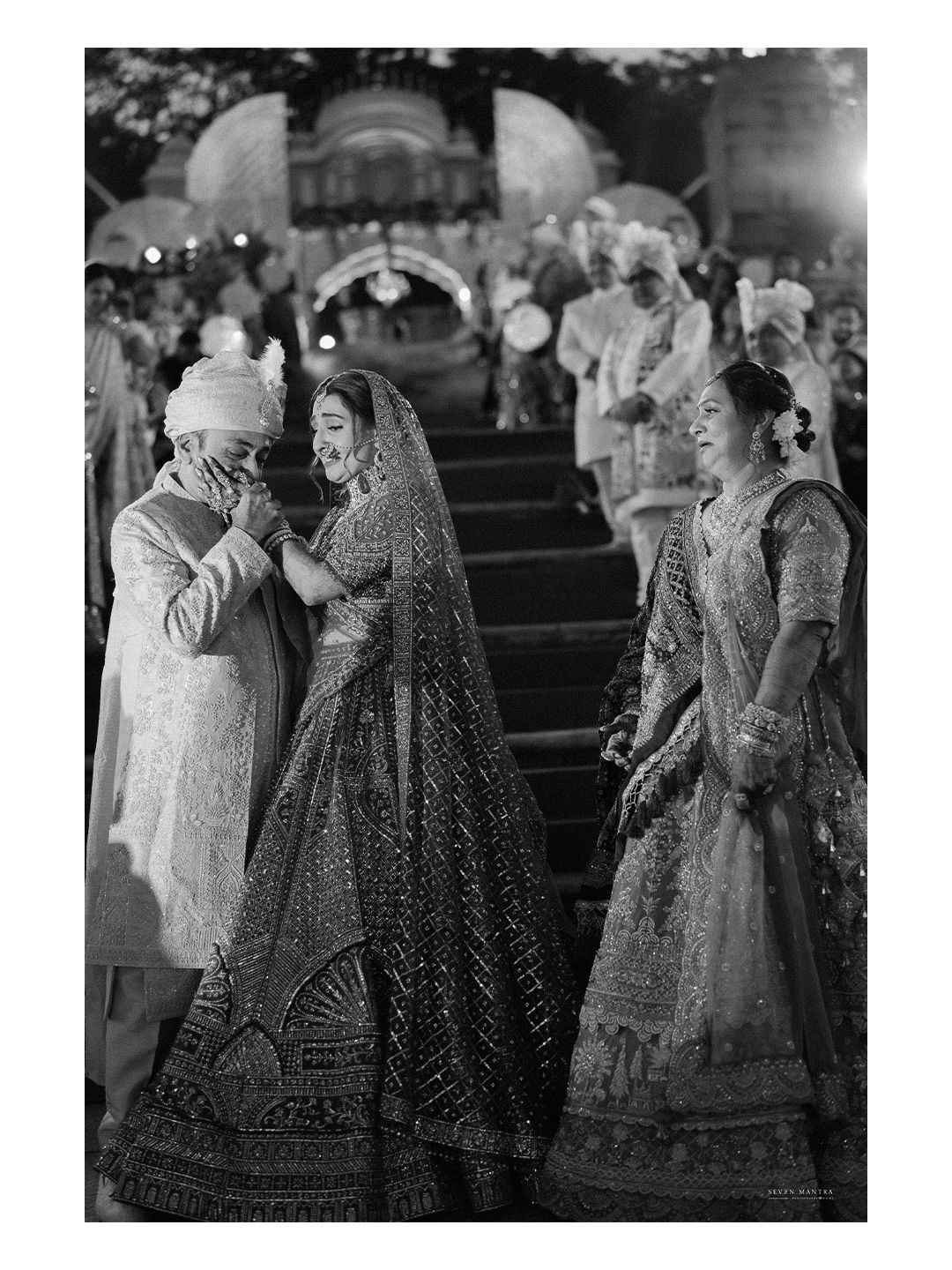 Emotional father covering his mouth as he sees his daughter in bridal lehenga at Indian wedding ceremony.