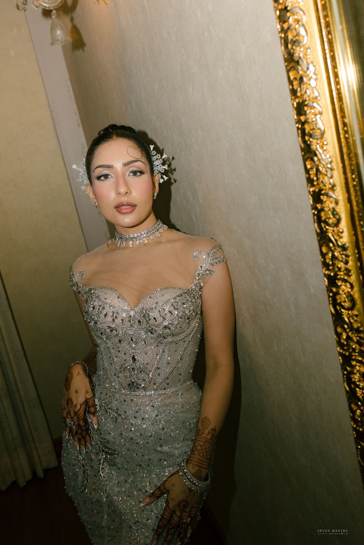 Elegant bride in silver embellished wedding gown with crystal hair accessories and diamond choker.