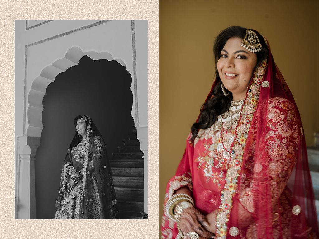 Indian bride in stunning red embroidered lehenga with gold jewelry and pink dupatta poses at traditional wedding.