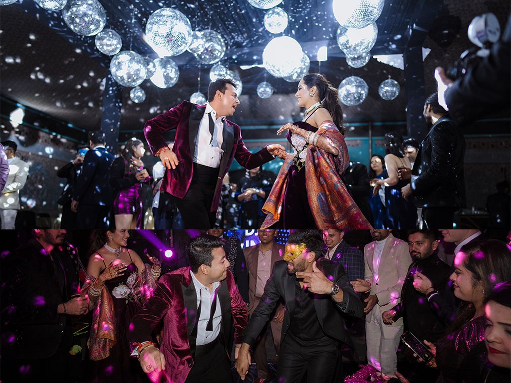 Couple lifted by guests on a vibrant disco-lit dance floor during an Indian wedding reception party.