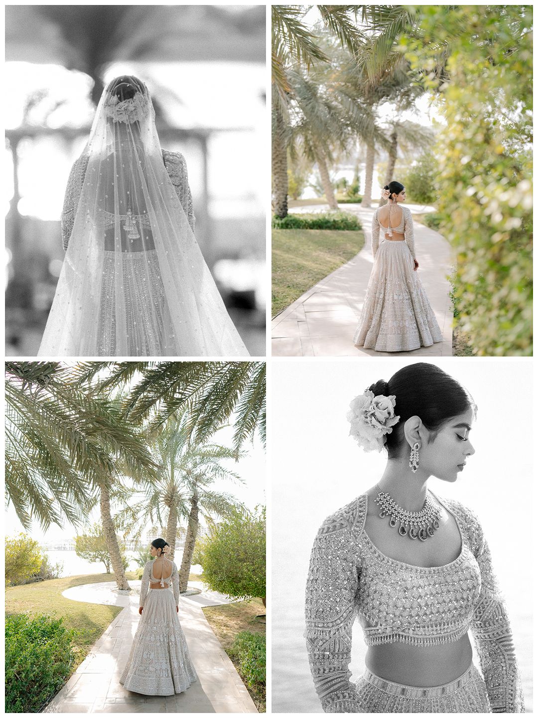 Indian bride in ivory embroidered lehenga with veil and floral hair accessory poses outdoors near palm trees.