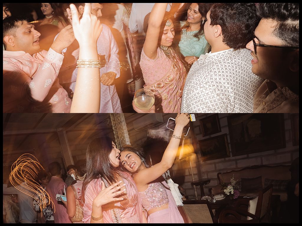 Indian wedding guests dancing joyfully at reception, bride in pink saree celebrating with friends and family.