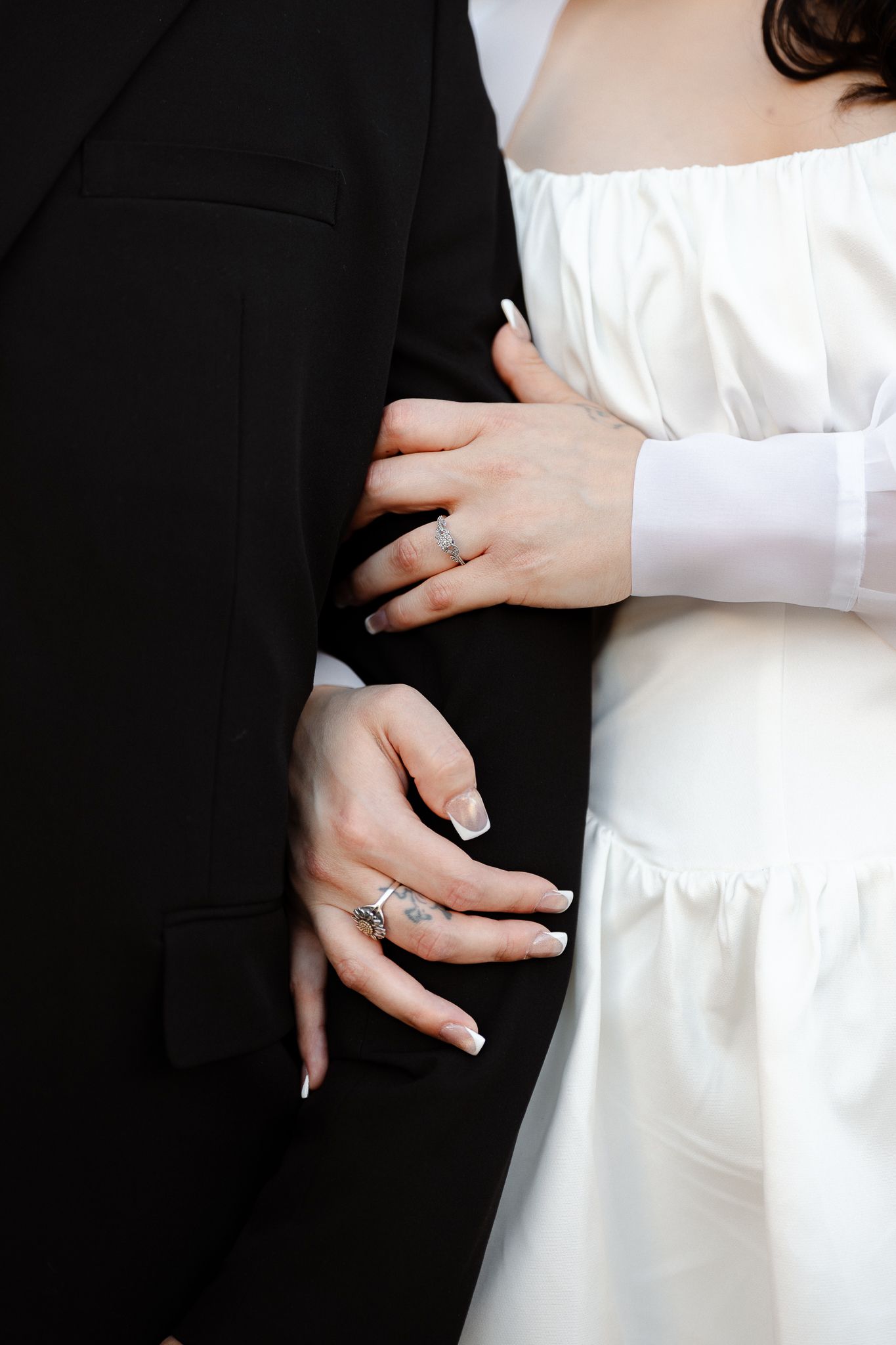 Close-up photo series showing hands against contrasting black and white clothing with dramatic lighting and composition.