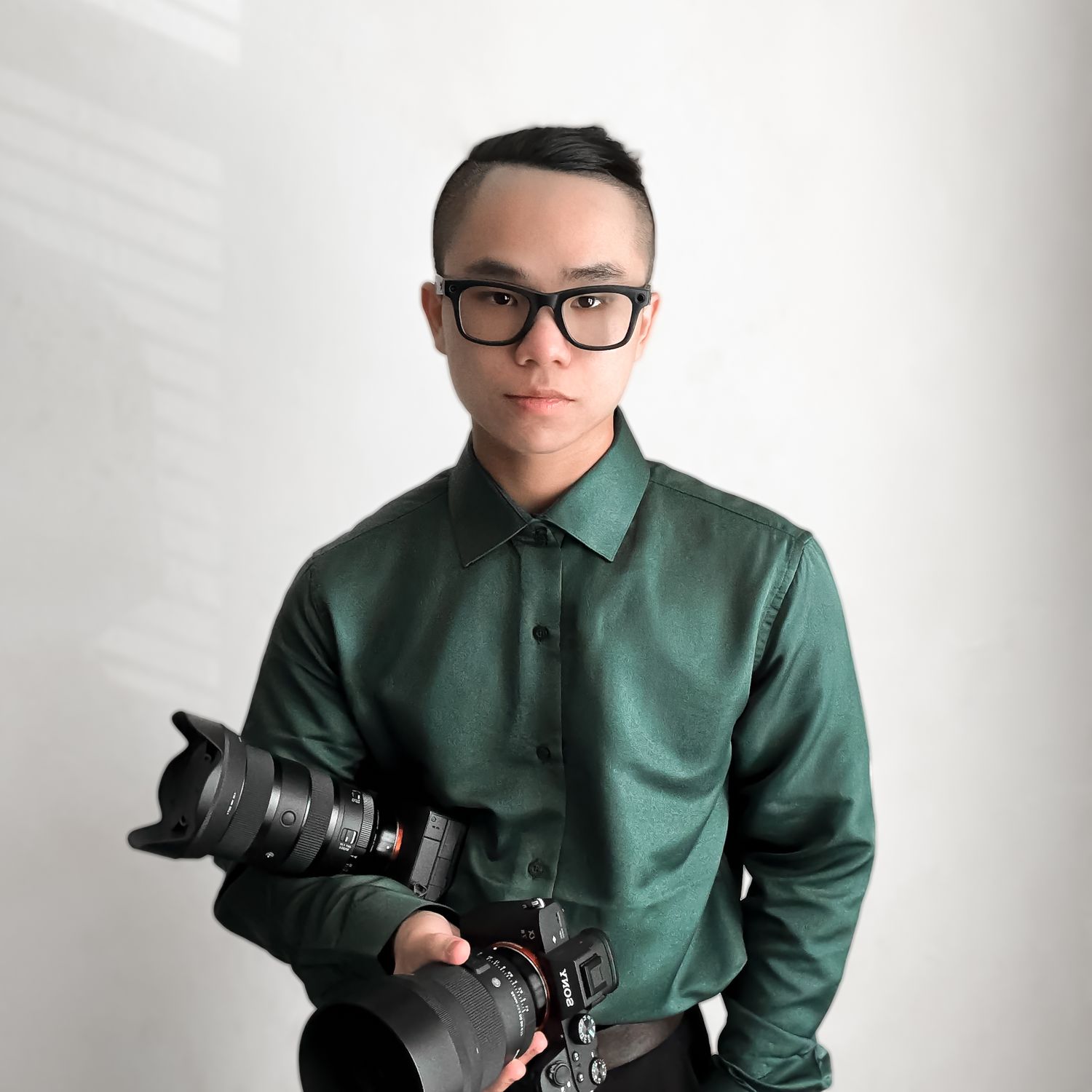 Professional photographer in green button-up shirt holding DSLR camera in various poses against white background.