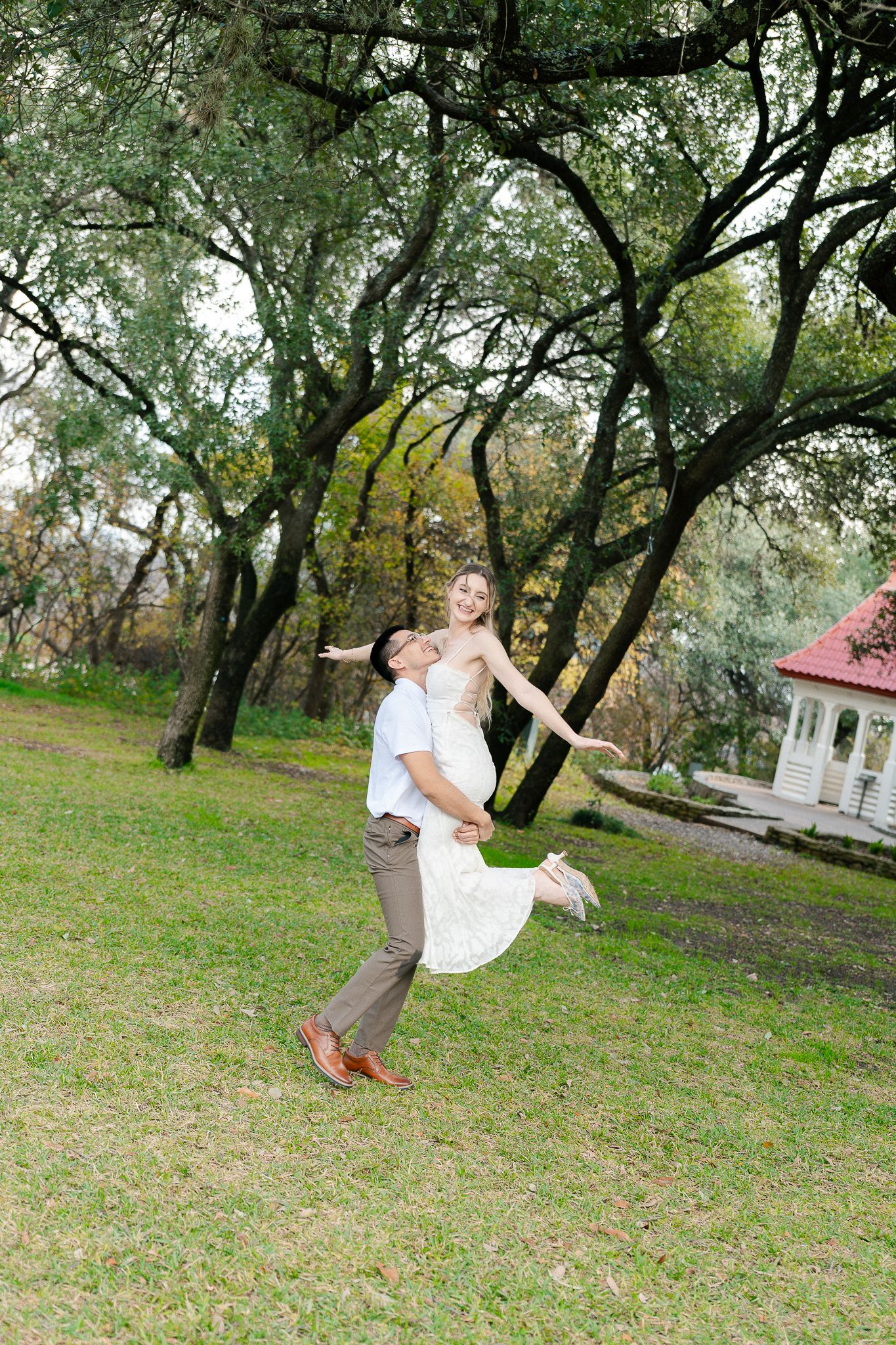 A sequence of four action shots shows a person swinging and spinning around a tree trunk in a grassy park setting.