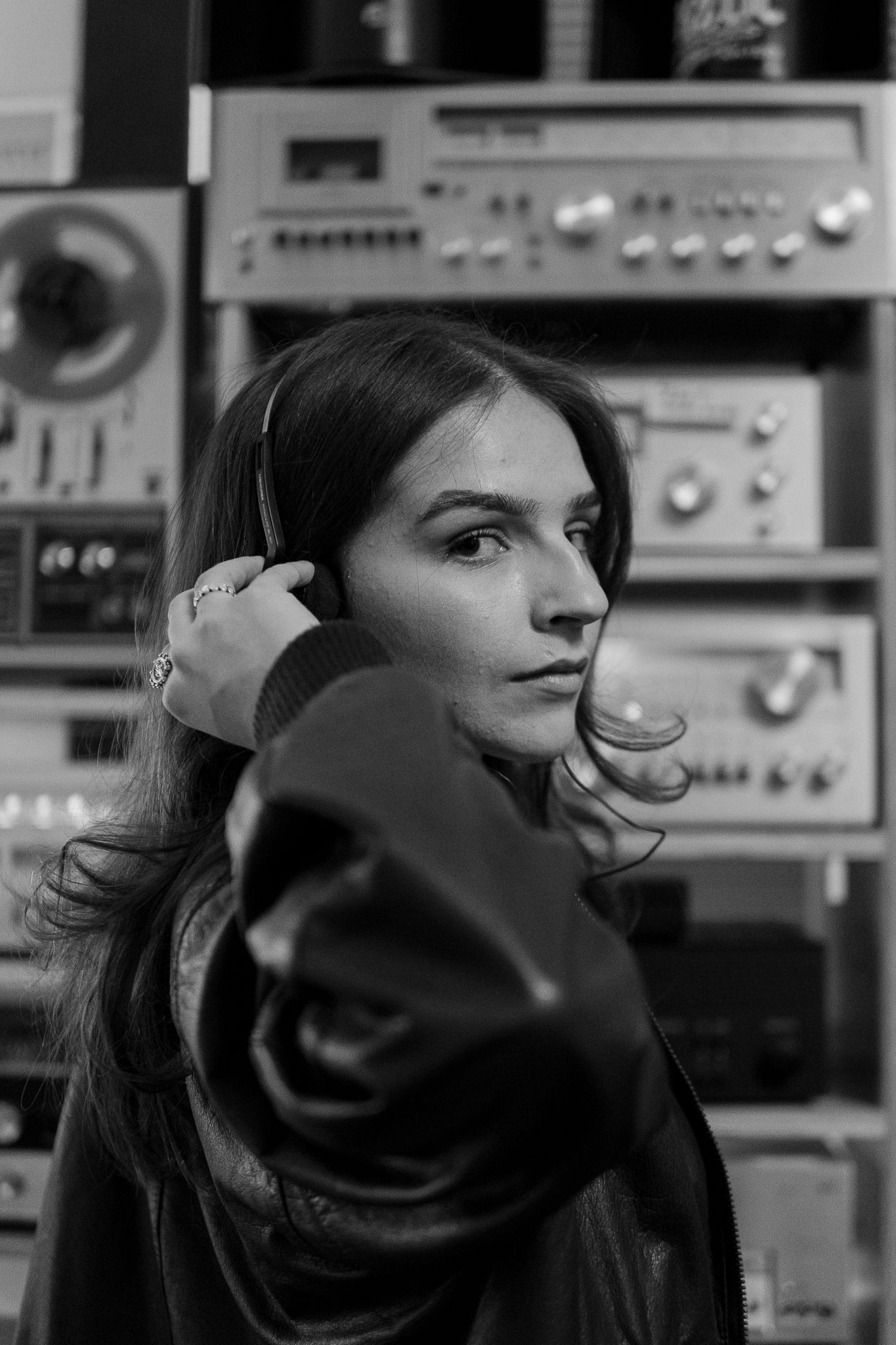 Black and white profile shots of a person in a recording studio with audio equipment in the background.