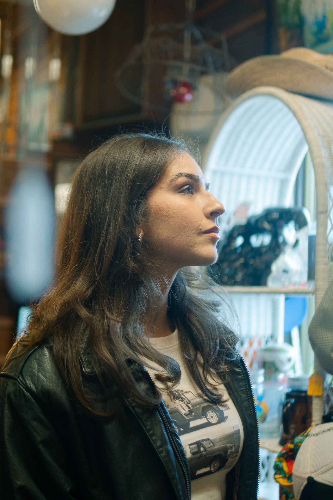 Profile views of someone with long dark hair looking upward in a series of connected photos.