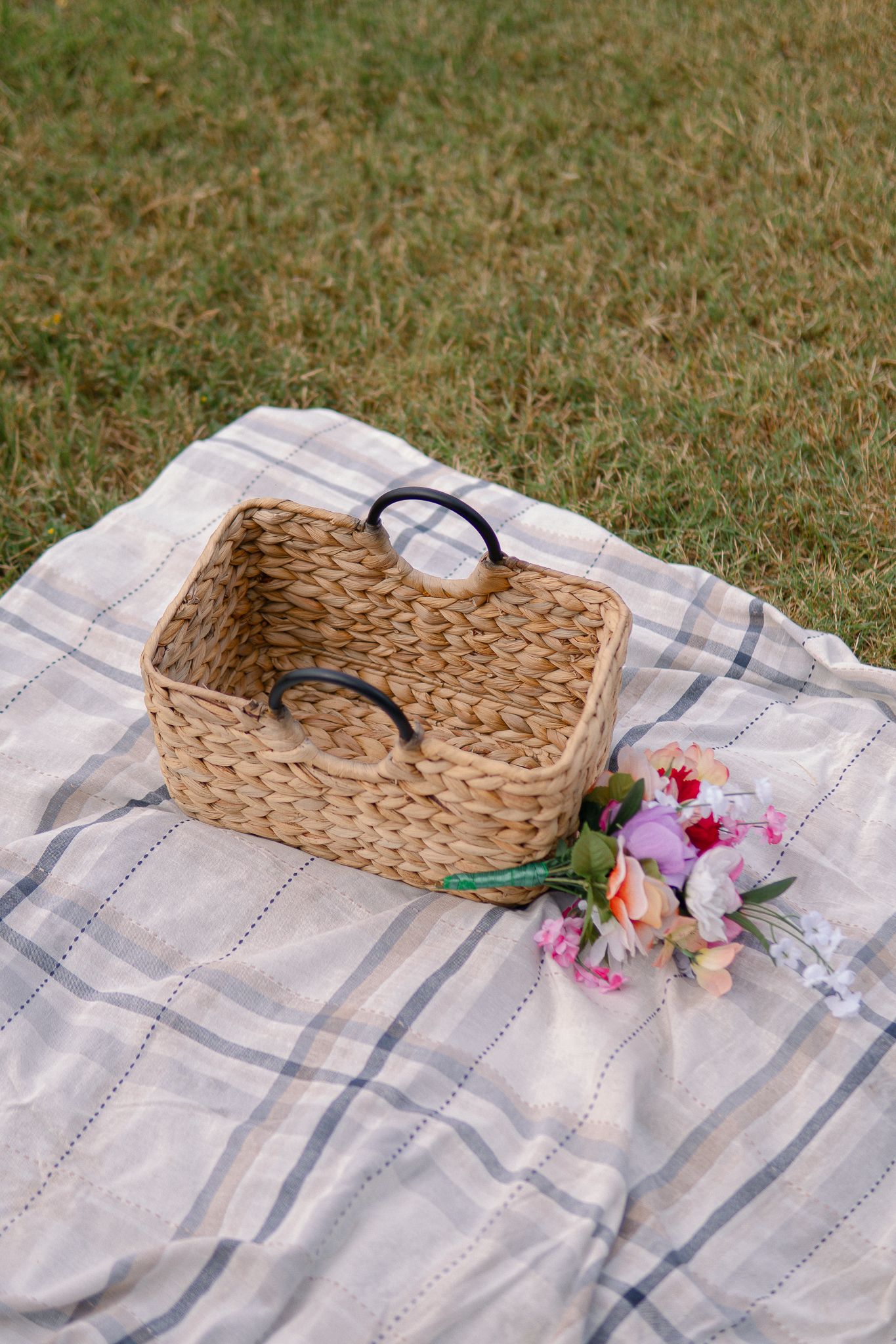 A sequence of photos showing a woven basket and floral decorations being arranged on a blue and white striped tablecloth.