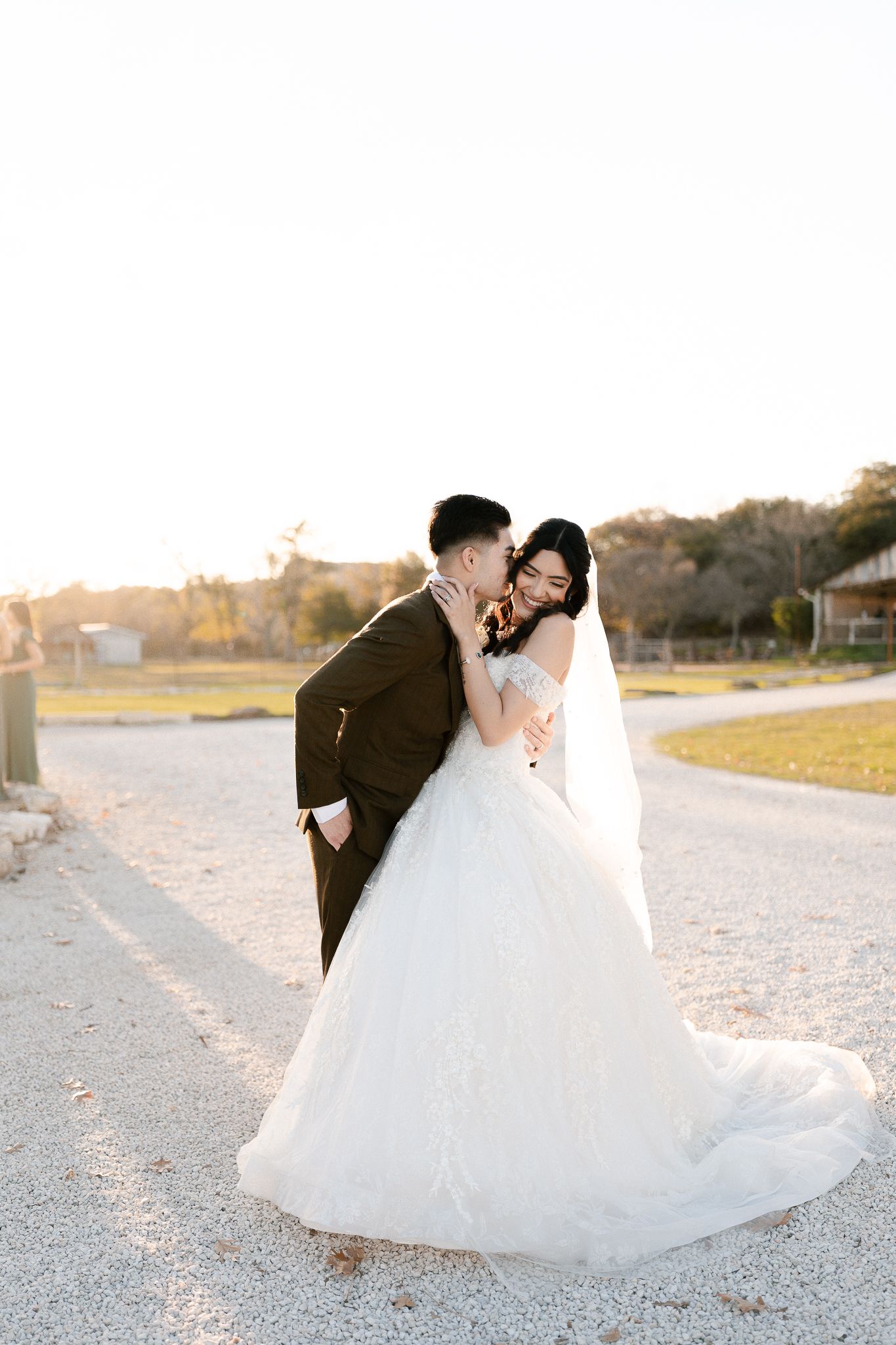 A romantic wedding photoshoot series showing a couple dancing and embracing on a sunlit path at sunset.