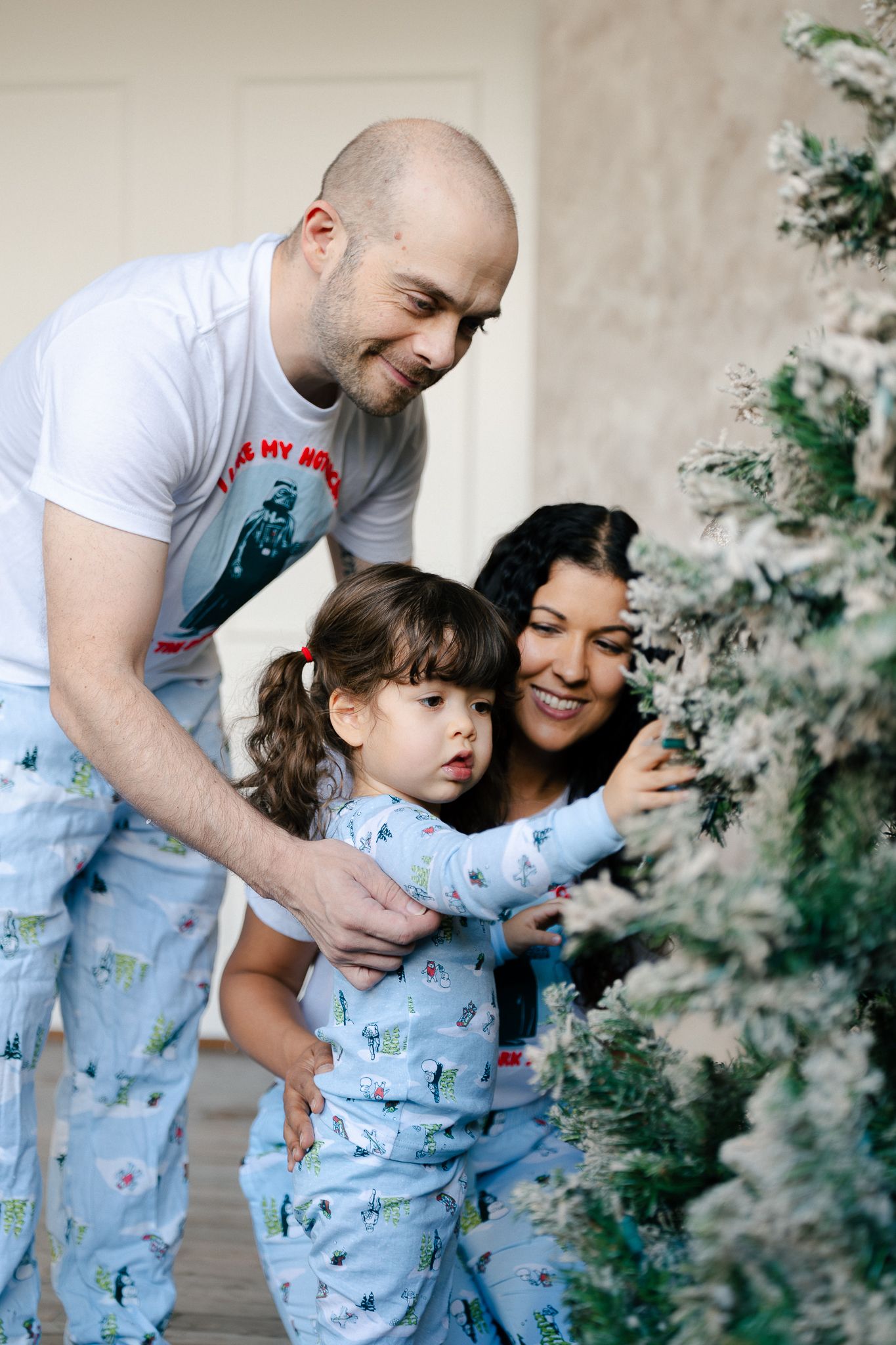 A parent and child in matching light blue pajamas share playful moments together in a series of candid photos.