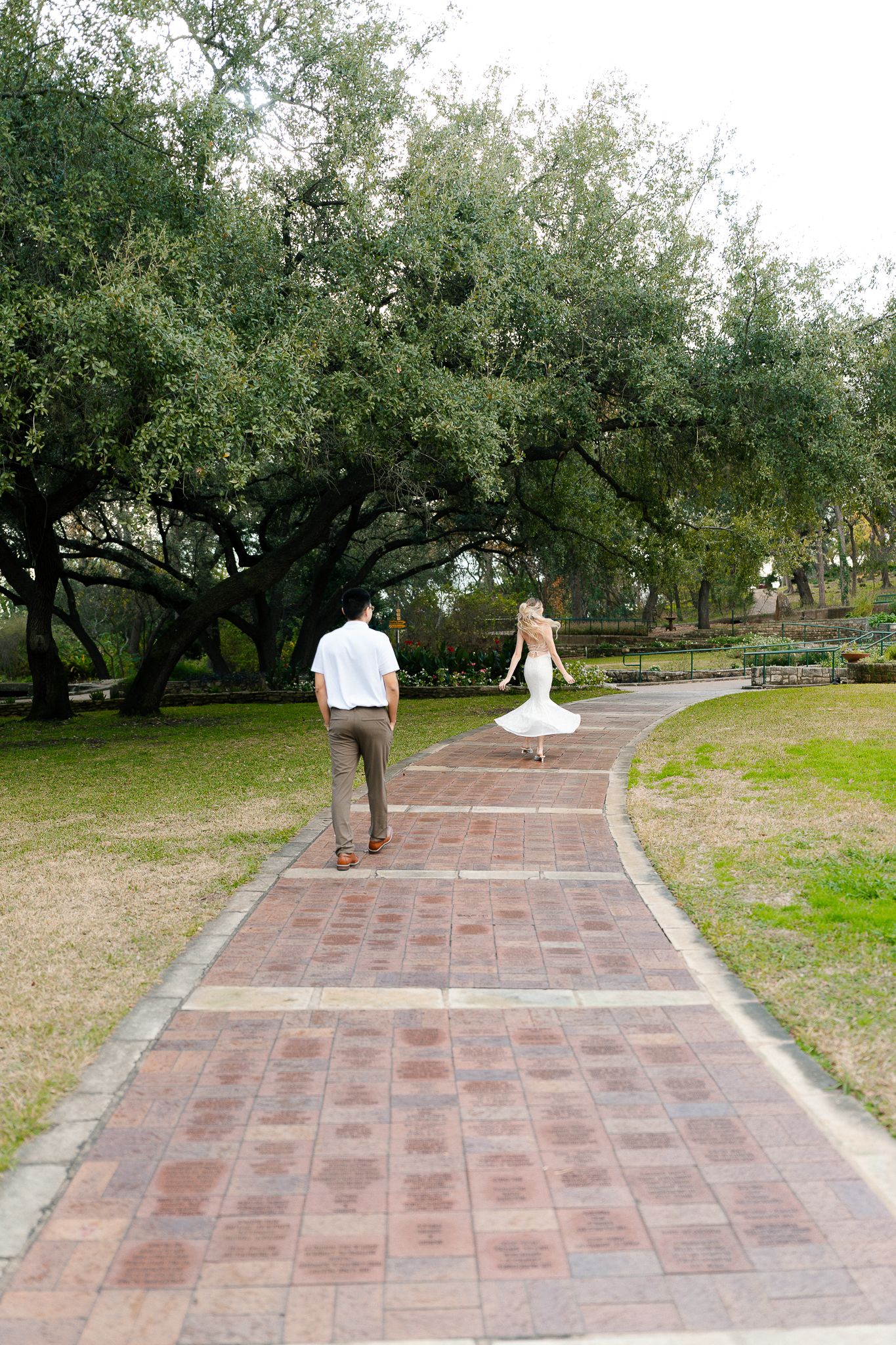 A series of photos showing a couple walking away down a brick pathway surrounded by olive trees in a garden setting.