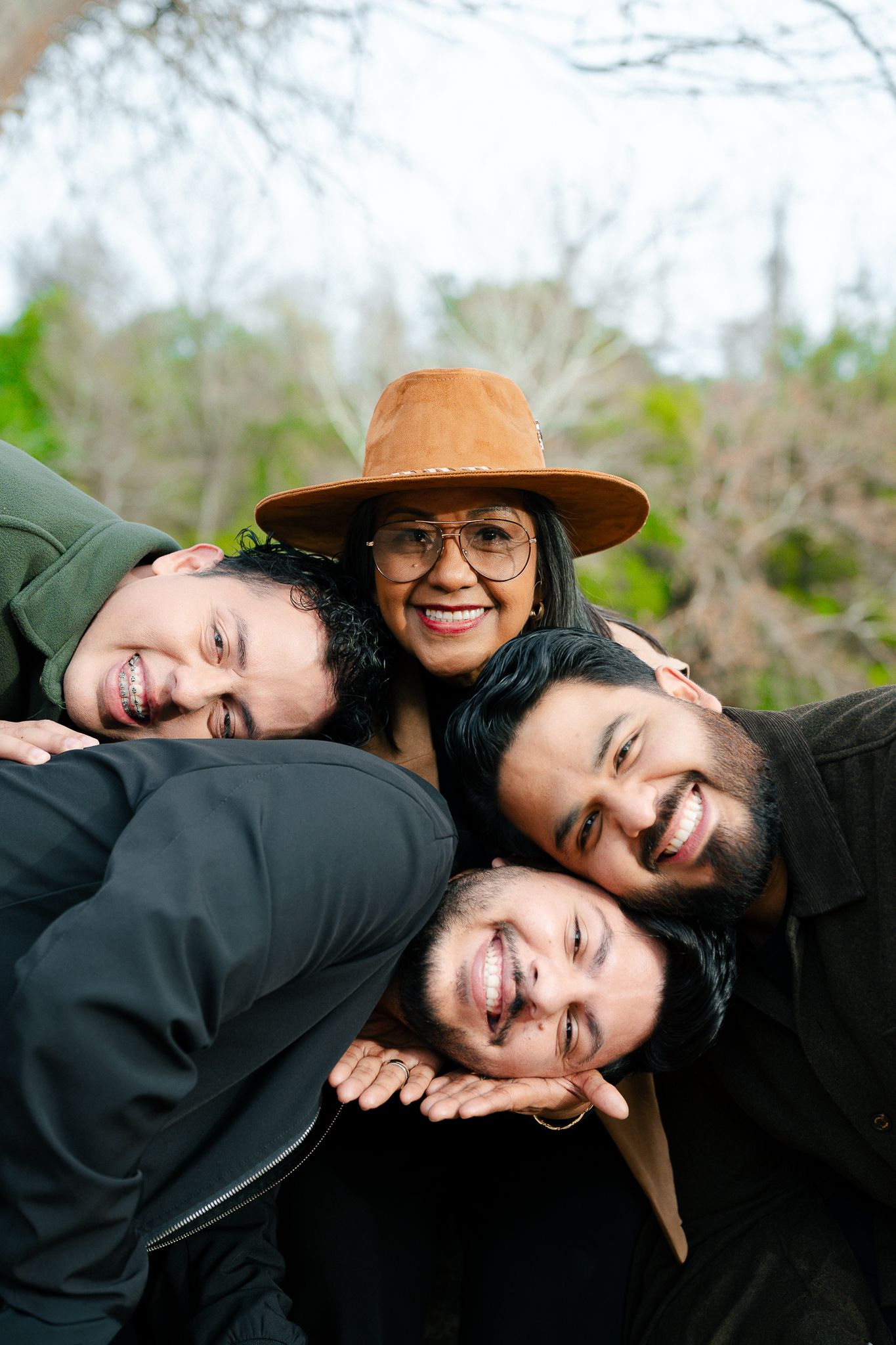A playful outdoor photo series showing a couple laughing and embracing while wearing casual attire.