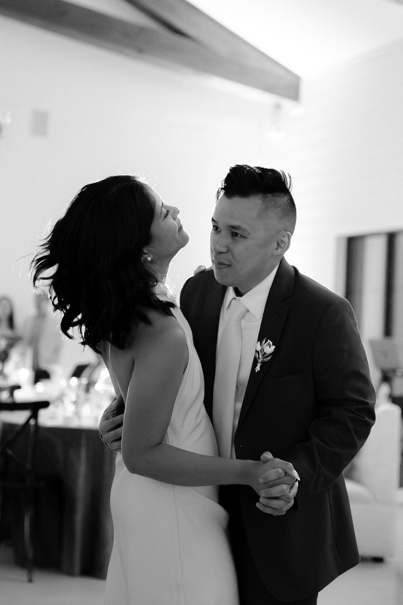 A romantic black and white photo sequence showing a couple's first dance at their wedding reception.