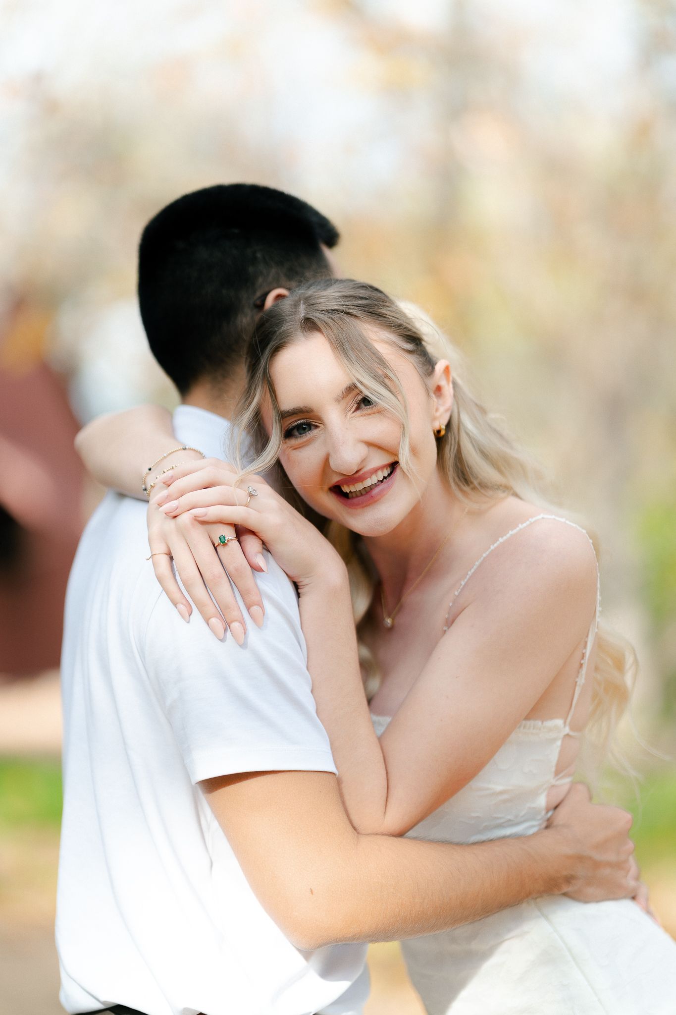 A couple embraces and shares intimate moments while posing together in a soft, natural outdoor setting.