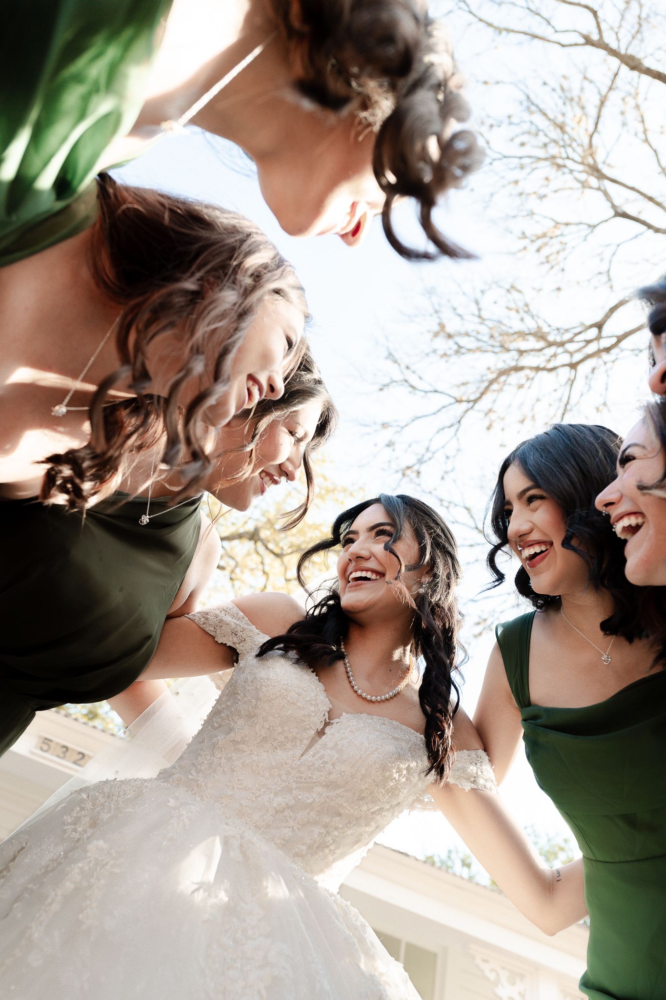 A sequence of candid shots showing a group laughing together in joyful celebration outdoors.