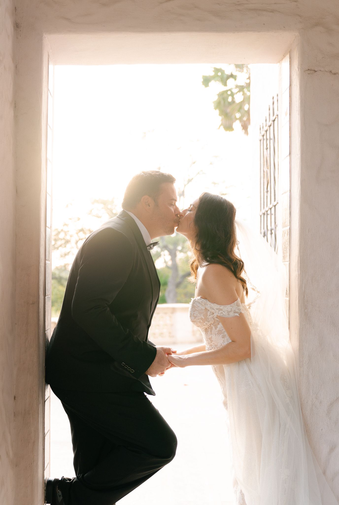 A romantic wedding couple shares five intimate moments in a series of artistic black and white photographs.