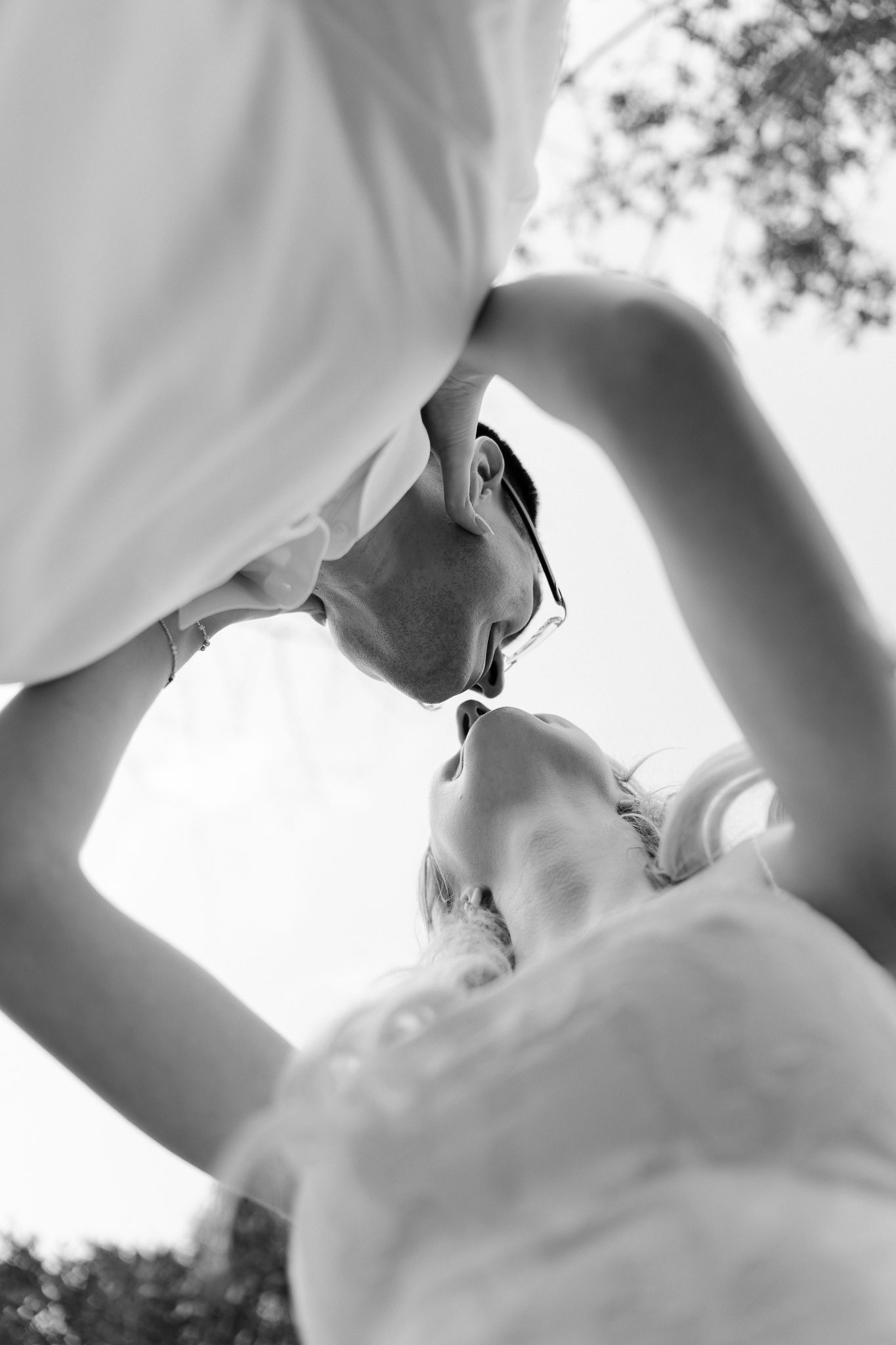 Black and white artistic wedding photo sequence showing intimate close-up angles of a romantic couple's embrace.