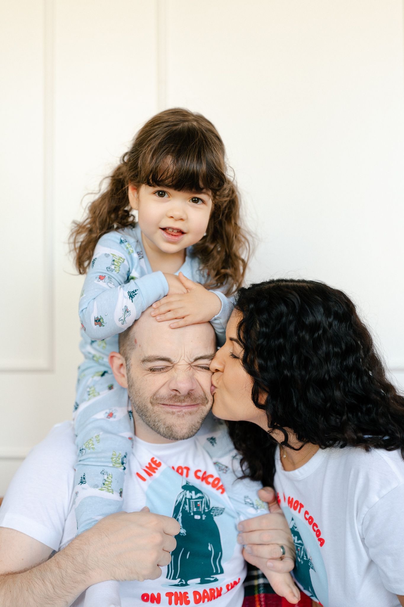 A series of candid moments showing affectionate interaction between two people wearing white t-shirts and pajamas.