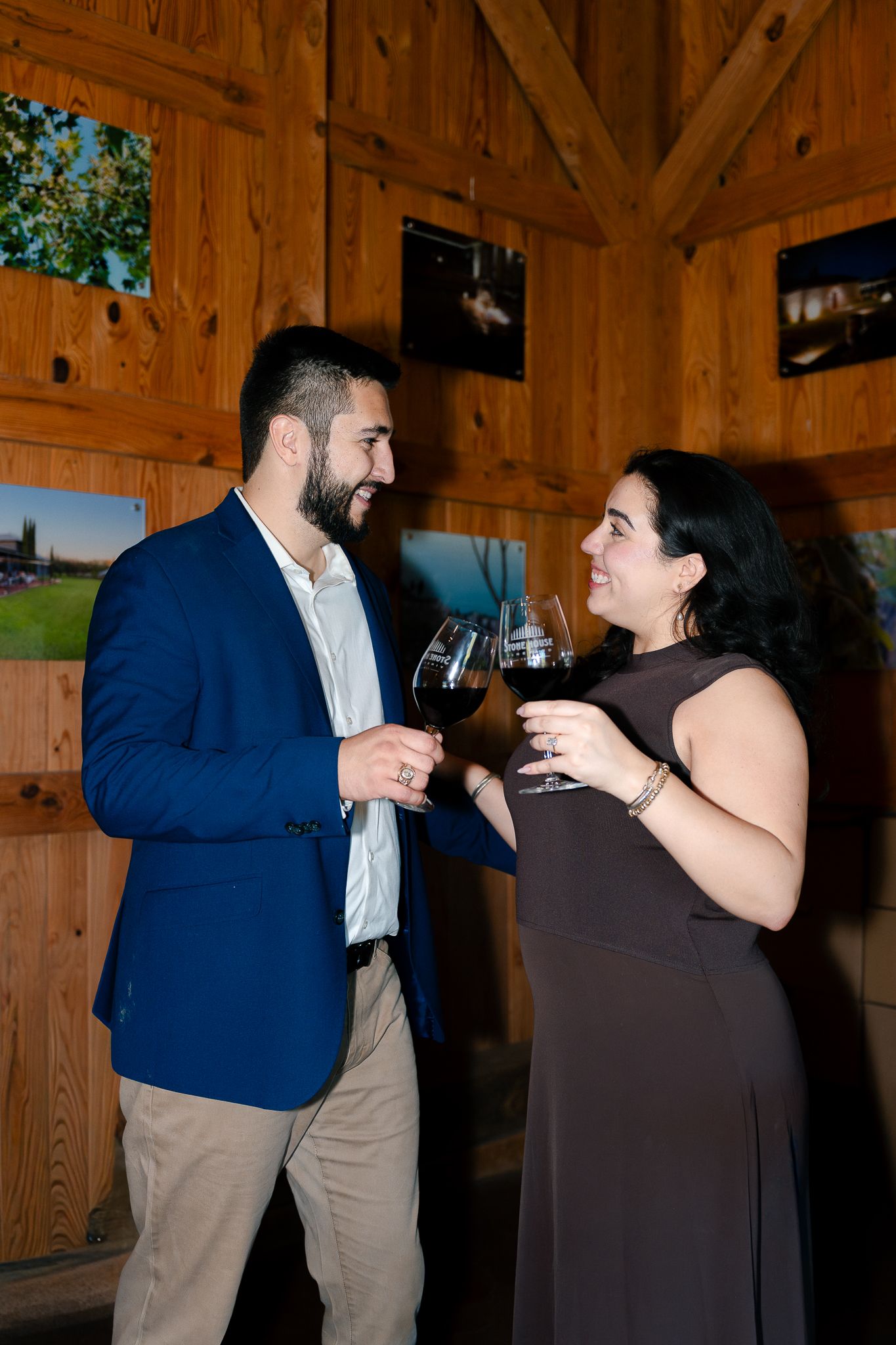 A couple shares an intimate dance moment in a rustic wooden barn venue.
