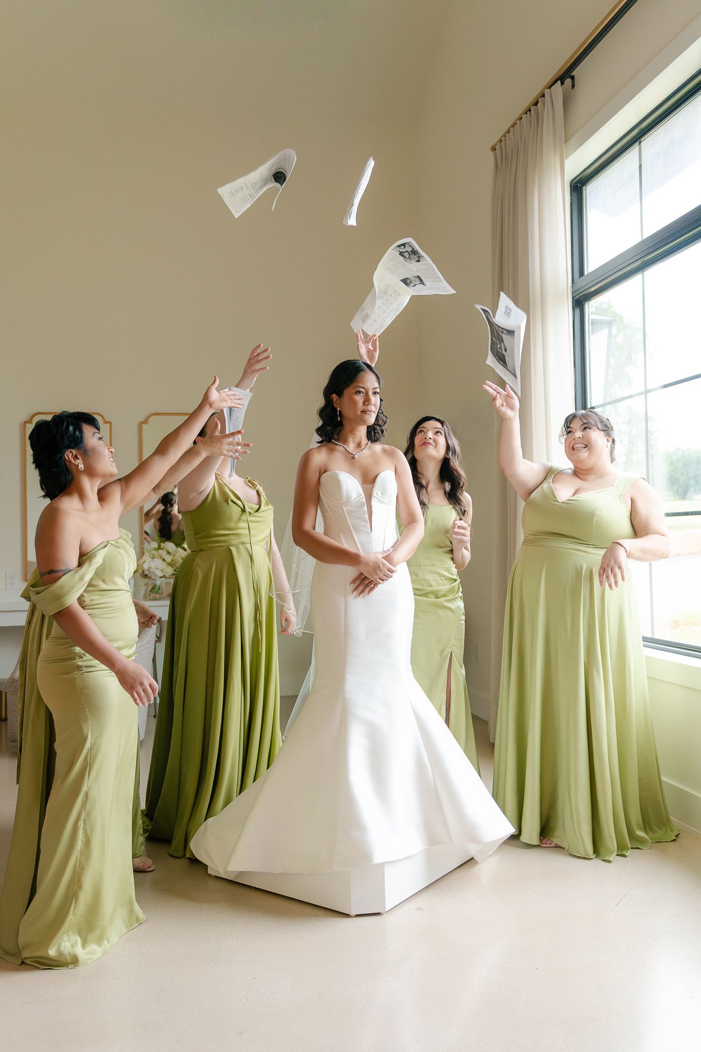 Bridal party in sage green dresses and white wedding gown pose playfully in sequence of candid celebration shots.