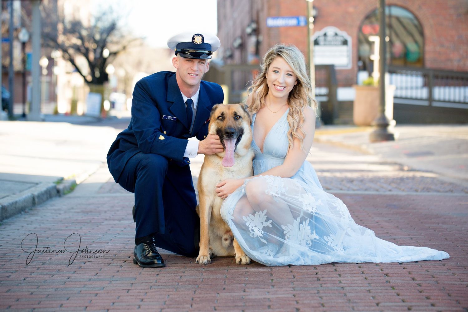 Sweet portrait with service dog and naval officer on brick sidewalk.