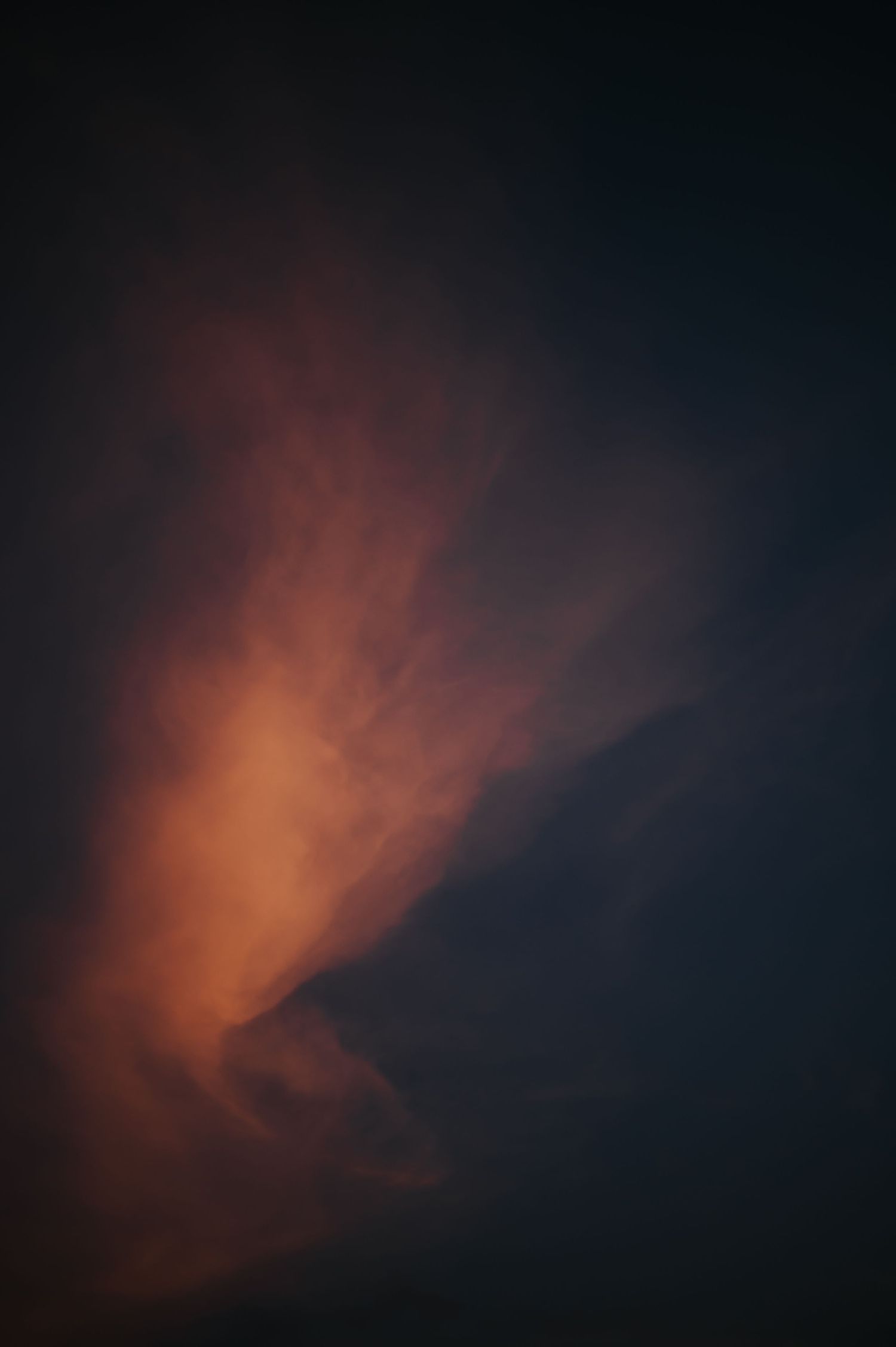 A series of dark sky photos showing dramatic orange and red sunset clouds against a black background.