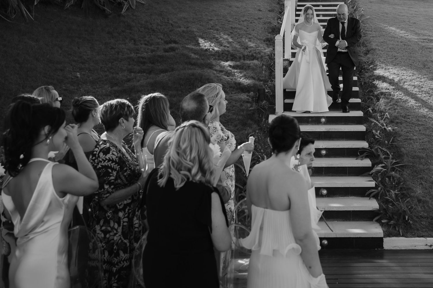 Black and white photo collage showing intimate moments from a wedding ceremony and reception celebration.
