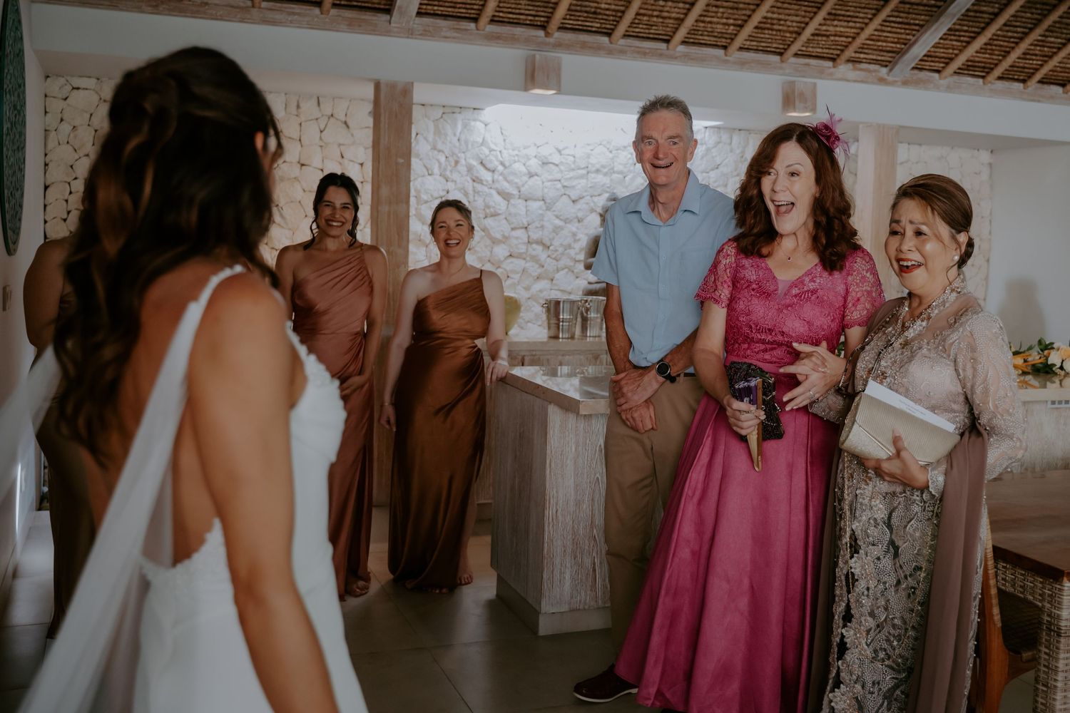 Wedding guests gather to celebrate and share emotional reactions during an intimate indoor ceremony.