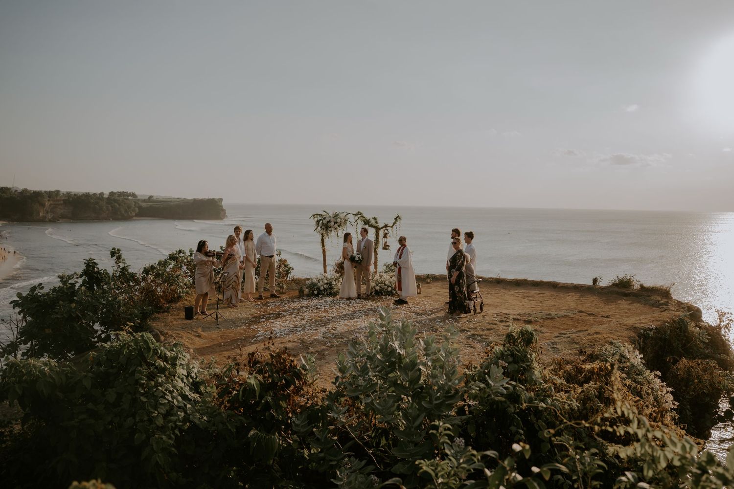 Panoramic coastal landscape view with cliffs and ocean at sunset.
