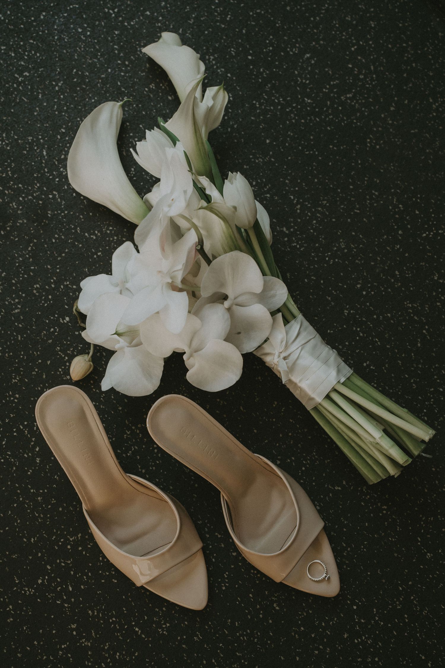 White tulip bouquet and beige leather mules arranged on dark speckled surface in a sequence of styled photos.