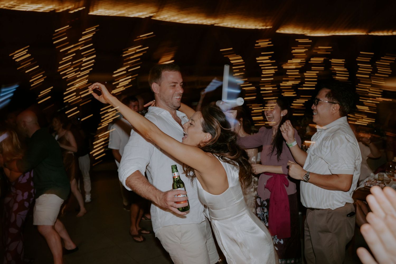 Couples dancing together at a dimly lit venue during what appears to be a social dance event or celebration.