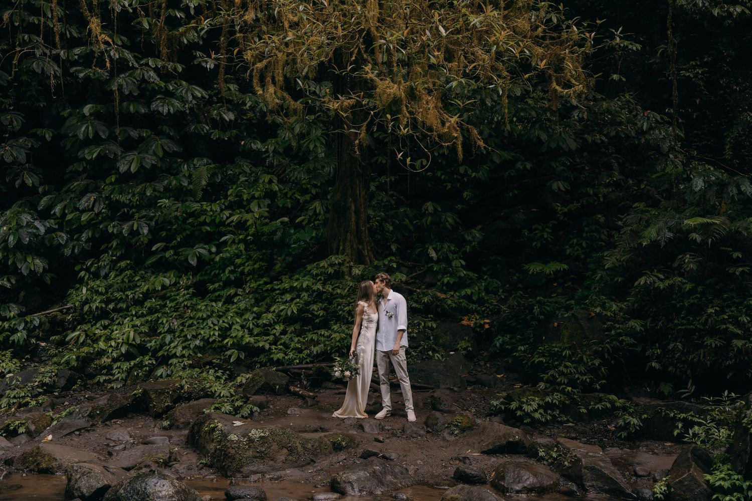 A series of romantic engagement photos taken in a lush forest setting during golden hour lighting.
