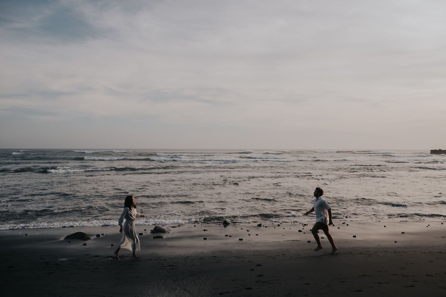 A series of black and white beach scenes showing silhouettes against a moody ocean landscape at dusk.