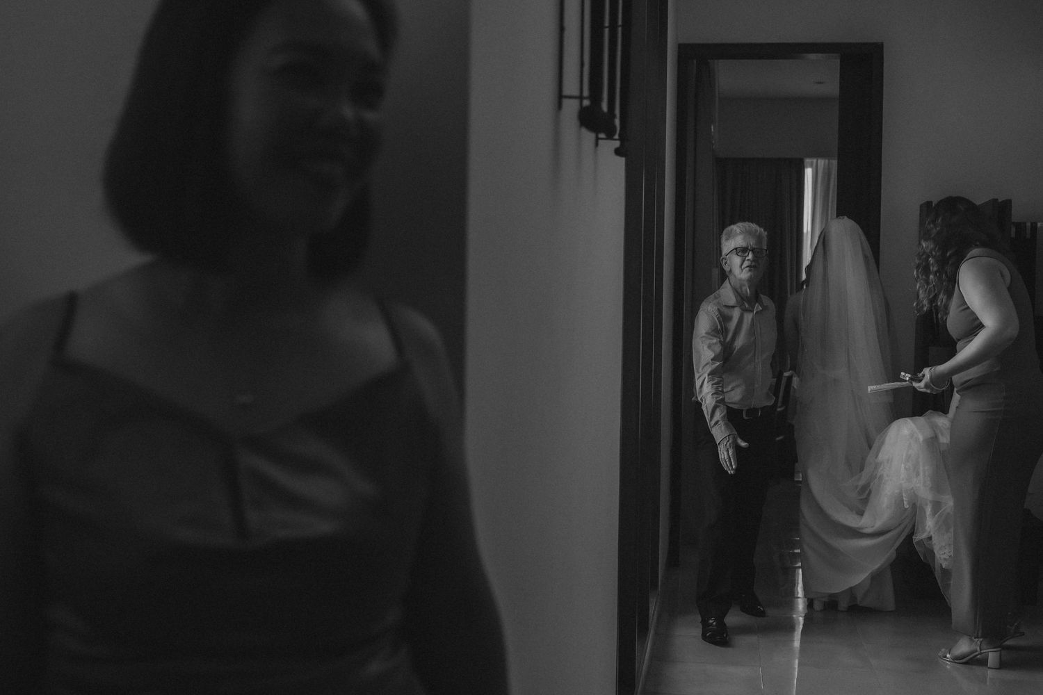 A black and white photo sequence shows a person walking through a doorway in multiple consecutive frames.