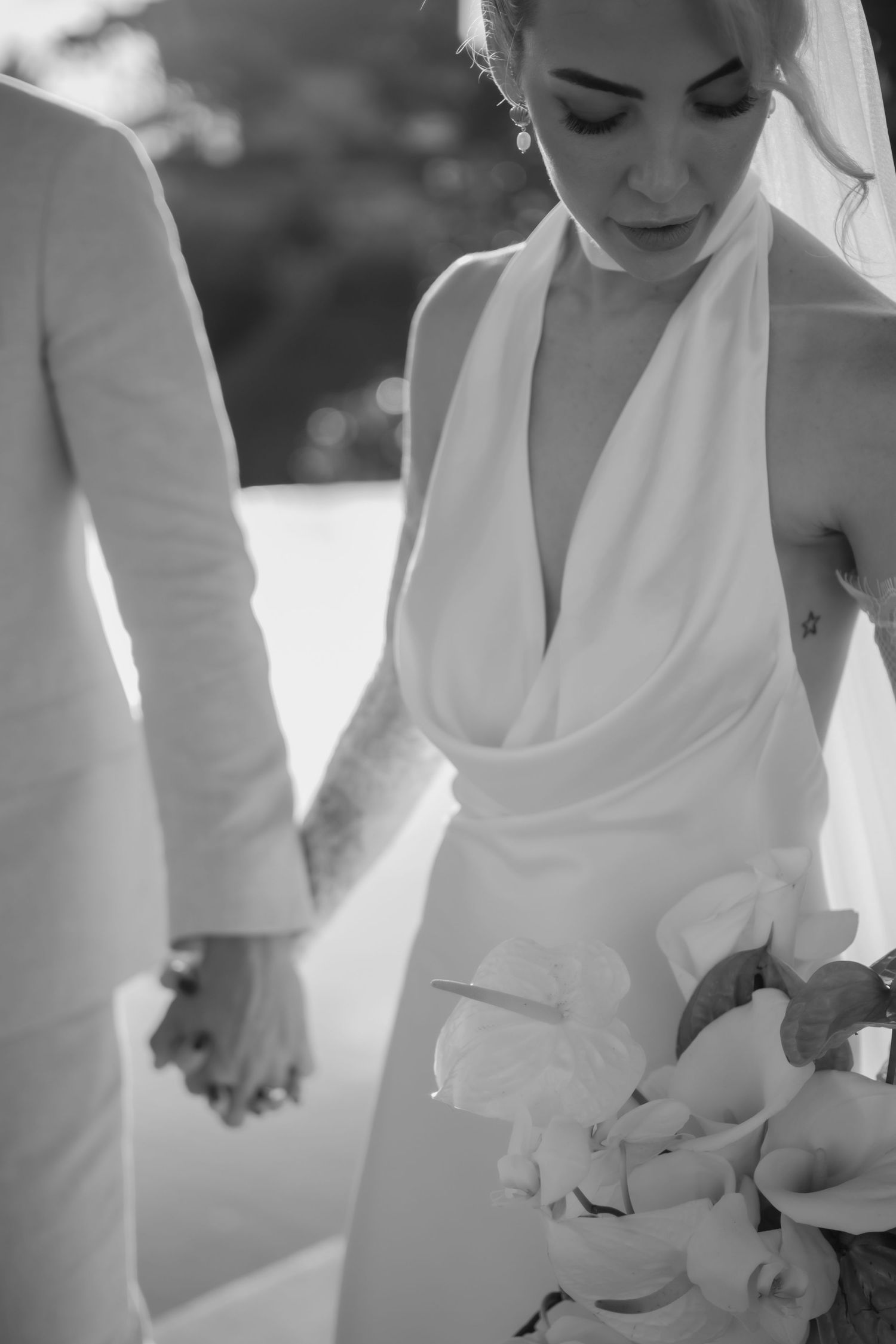 Elegant black and white detail shots of bride's wedding dress and accessories.