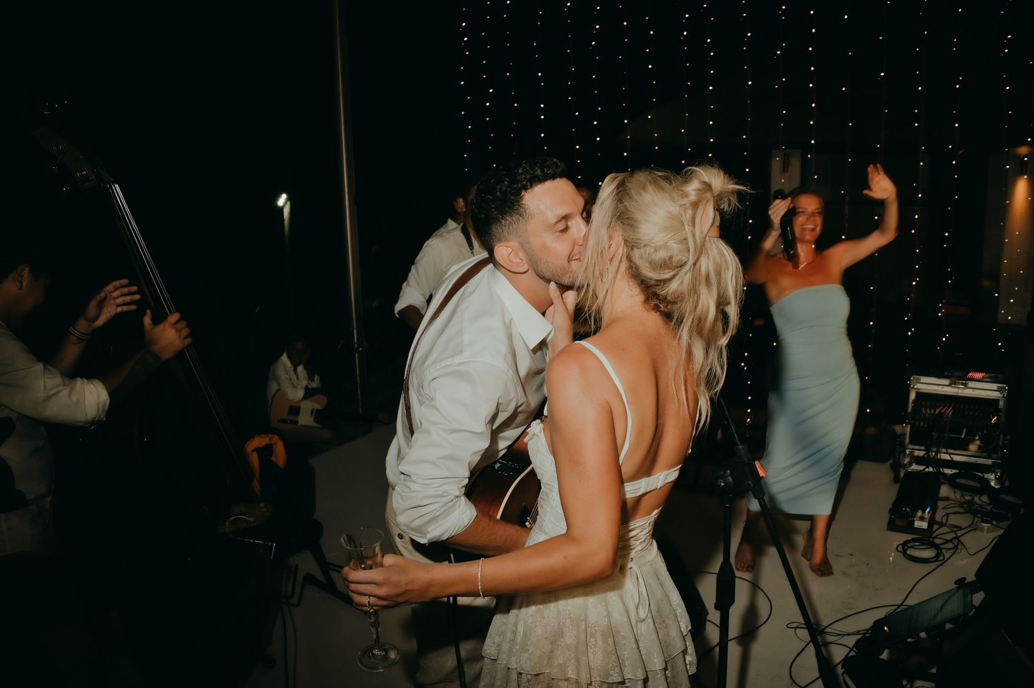 Bride and groom share a kiss on the dance floor during their wedding reception.