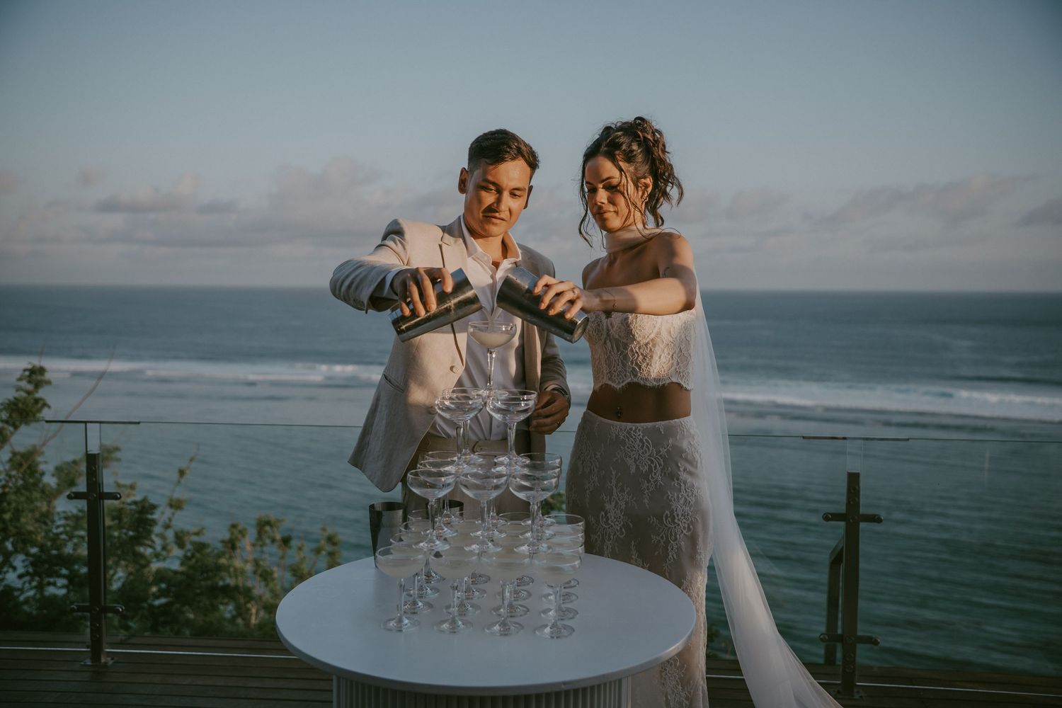 Oceanside wedding reception setup with champagne glasses and stunning sea views.