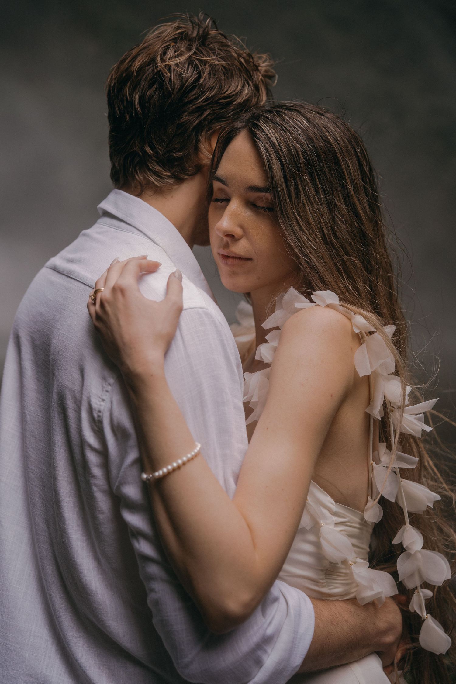 A romantic couple embraces in a series of intimate black and white photos showing tender moments together.