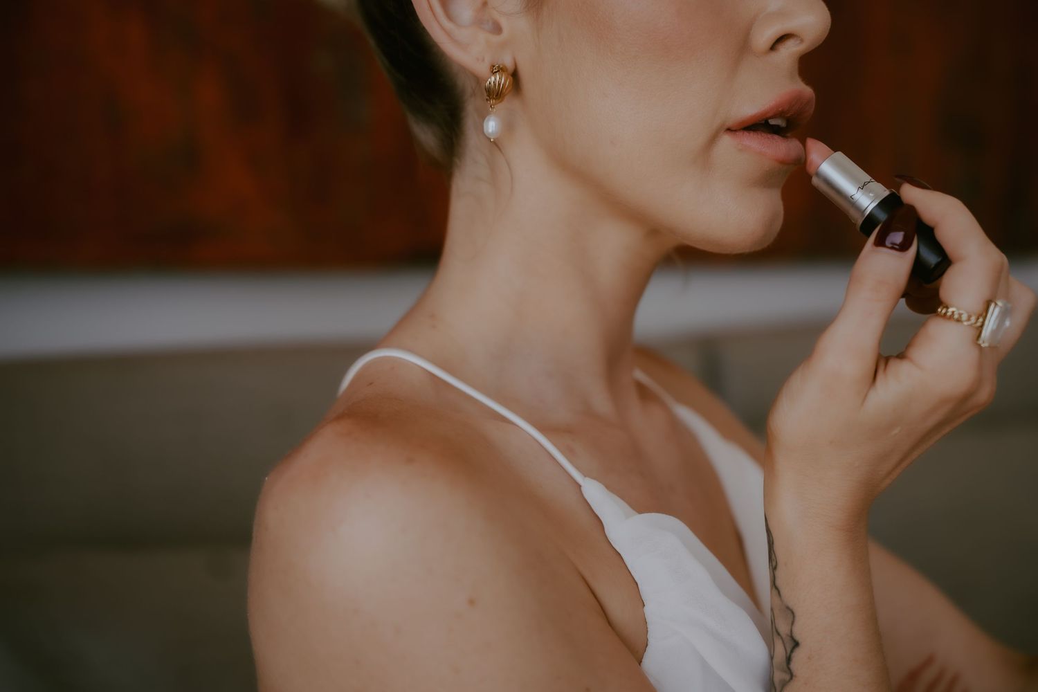 Close-up beauty shots showing makeup application and wedding day preparations.