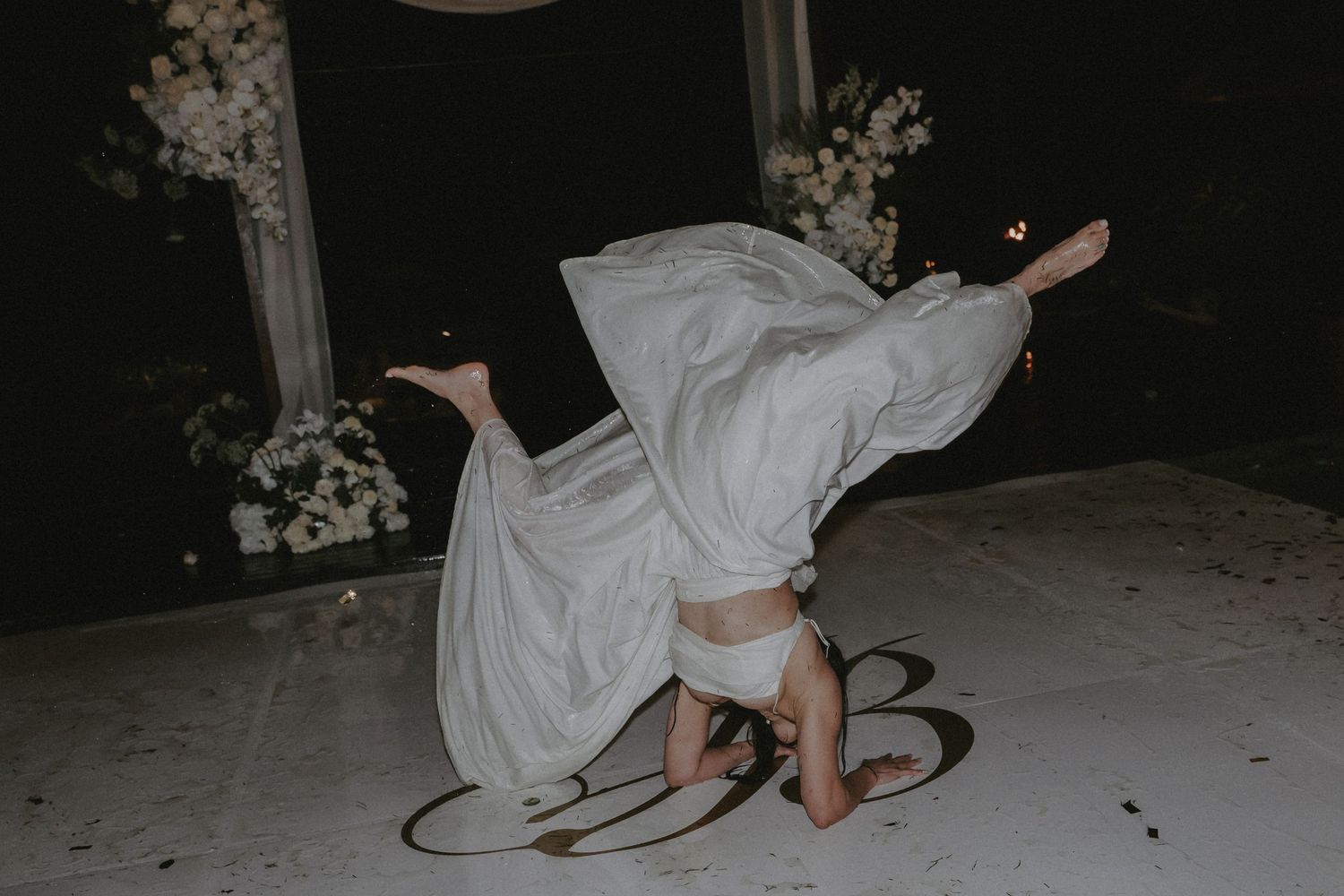 A sequence of artistic wedding photos showing white dress movement against a dark background.