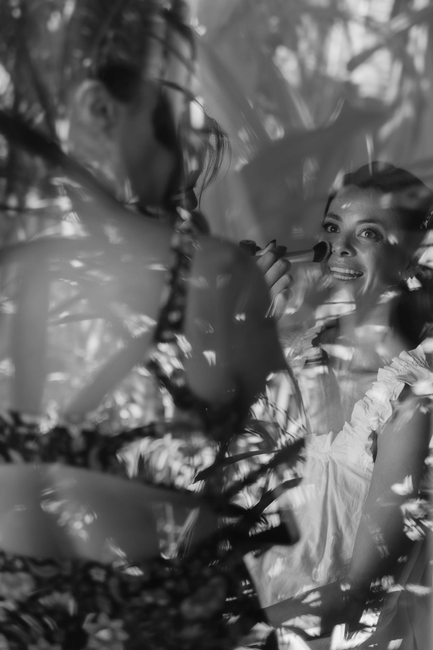 A black and white artistic portrait series showing shadowy silhouettes through leaves and branches creating a dreamy effect.