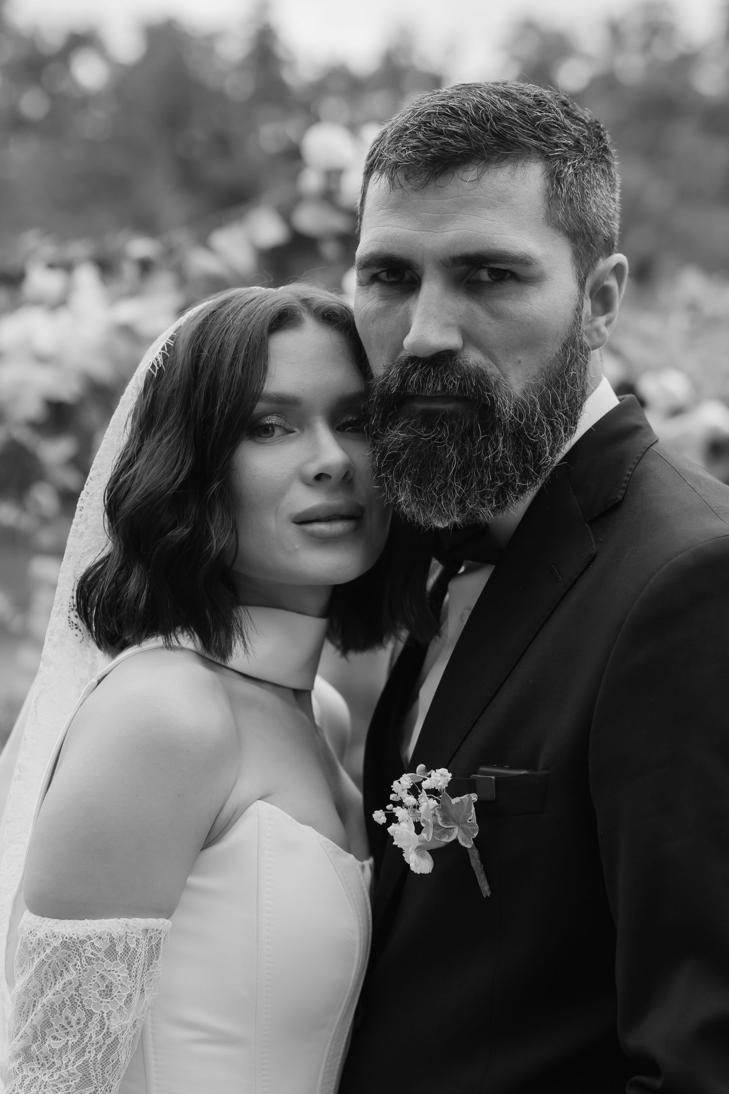 Black and white romantic wedding photography series showing intimate moments between bride and groom with moody lighting.