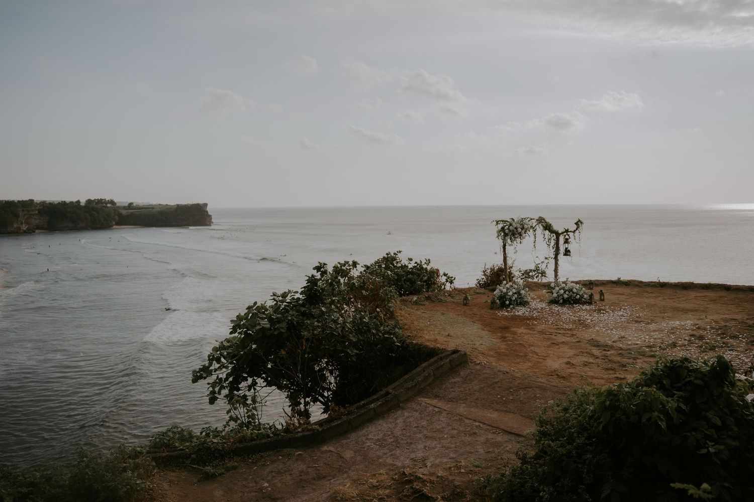 A panoramic sequence of moody coastal landscapes with palm trees and cloudy skies over a beach.