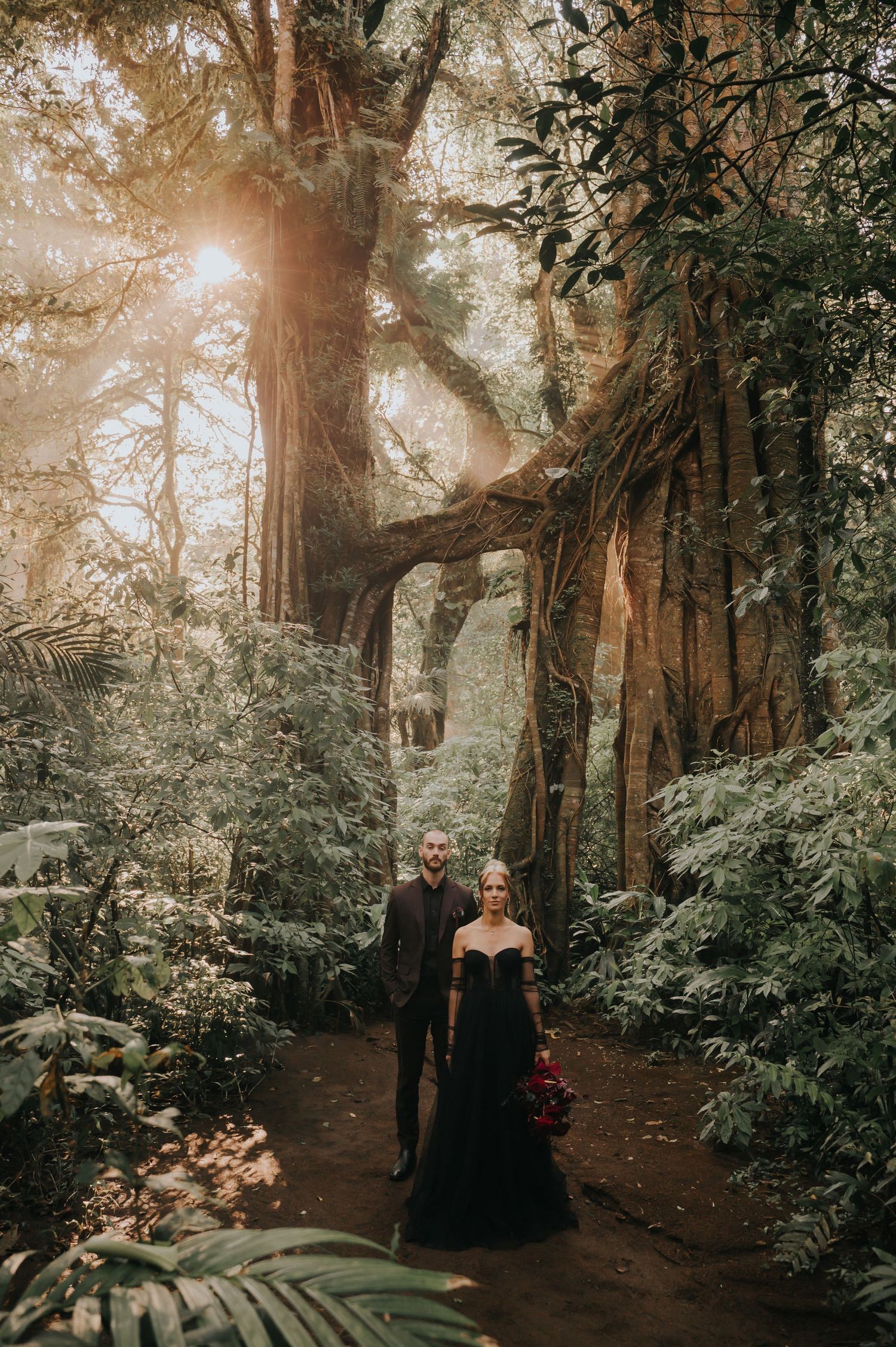Enchanted forest wedding photoshoot with towering trees and natural lighting.