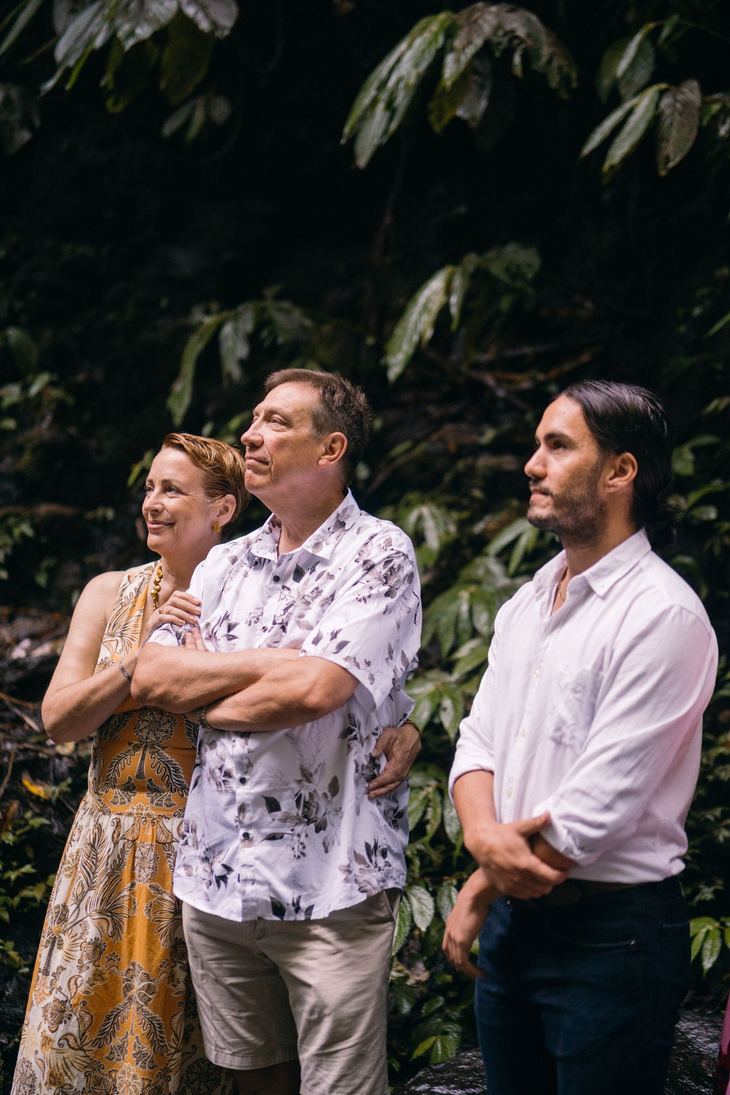 A series of candid photos showing a couple embracing and laughing together in an outdoor garden setting.