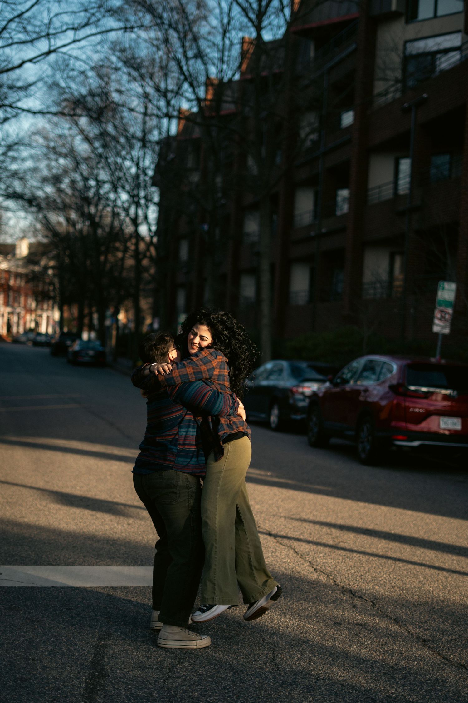 A couple embraces in the street.