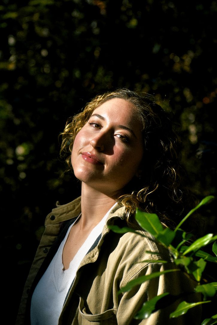 Headshot of a woman smiling in the forest.