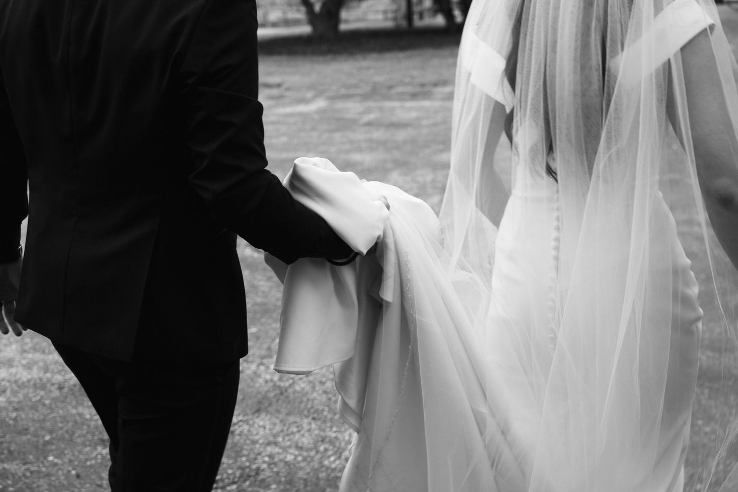 A black and white wedding photo collage showing romantic moments between a bride and groom in outdoor settings.